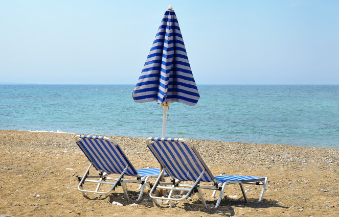 two blue striped beach lounge chairs