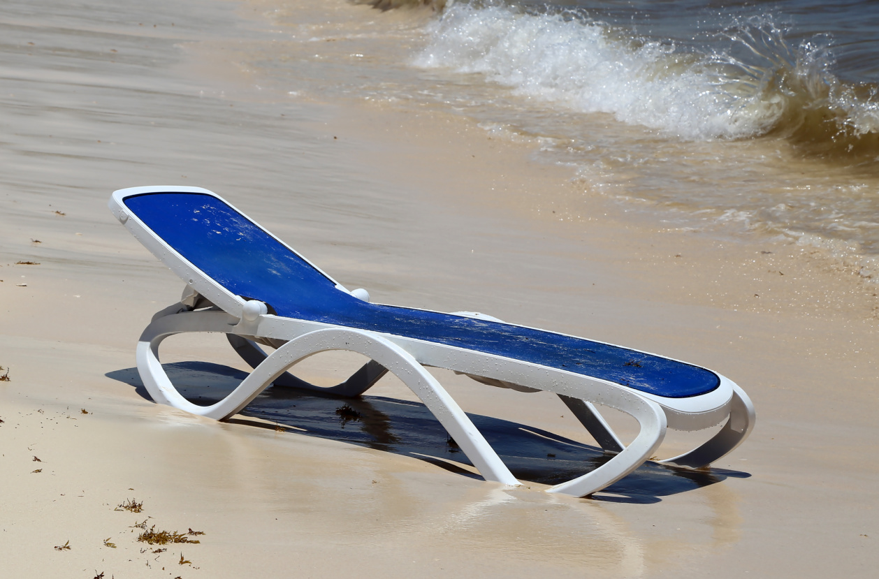 blue beach lounge chair near the ocean